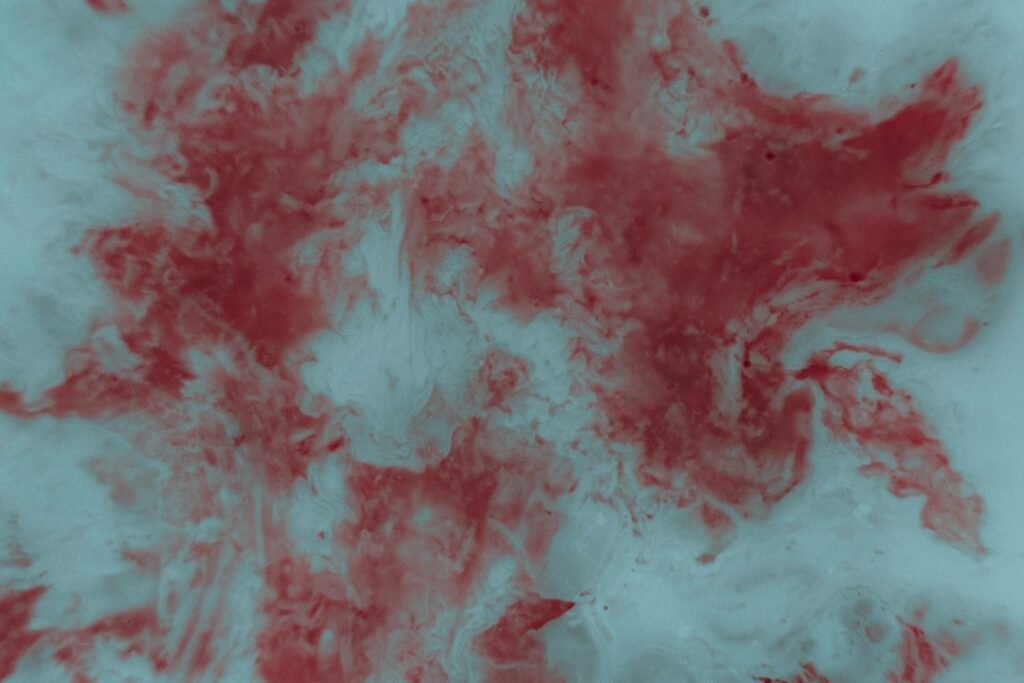 Abstract red and white marbled texture.