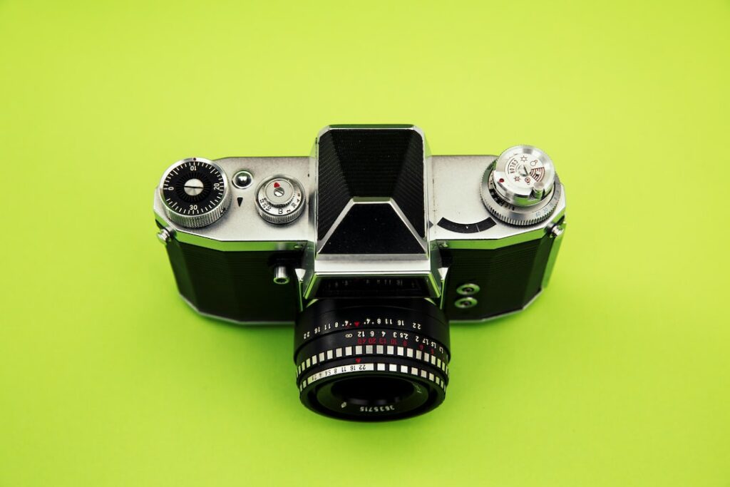 Vintage camera on green background.