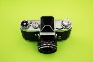 Vintage camera on green background.