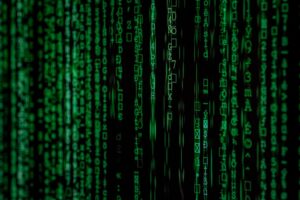 Green digital binary code data stream background.