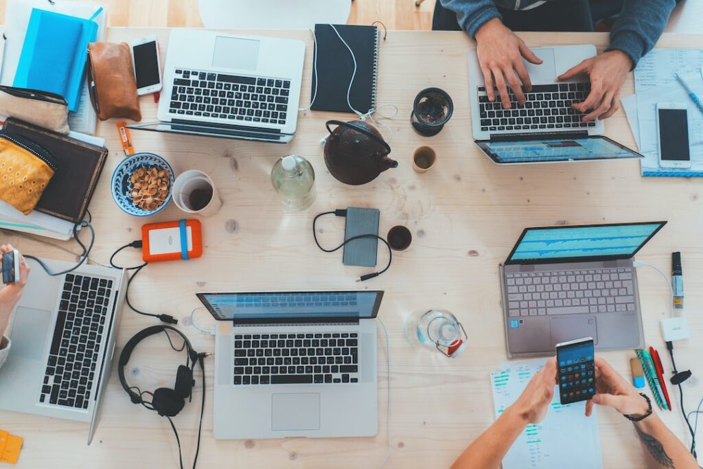 Collaborative workspace with laptops and mobile devices.