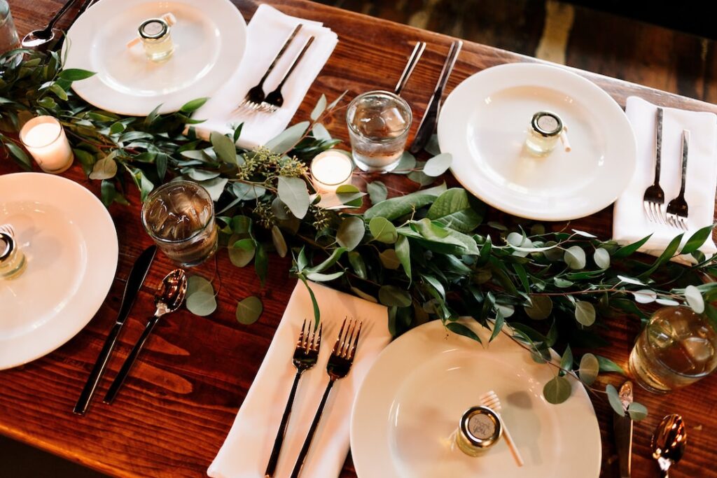 Elegant table setting with foliage and candles.
