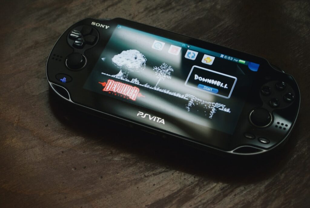 Sony PS Vita handheld gaming console on table.