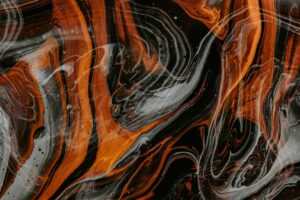 Abstract orange and black marbled pattern background.