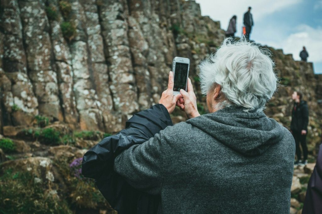 Senior capturing nature with smartphone.