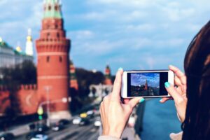 Person capturing Kremlin view on smartphone camera.