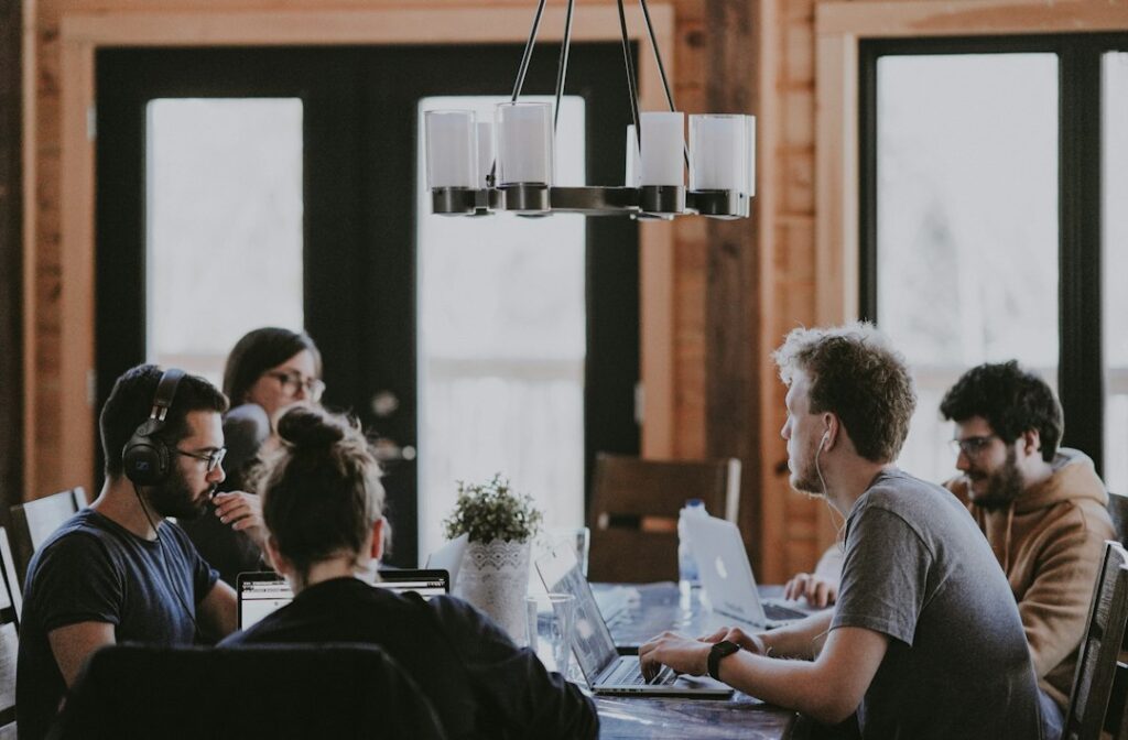 People working together in modern office with laptops.