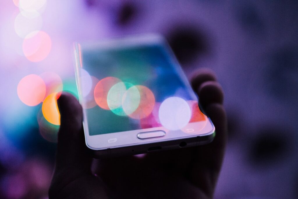 Smartphone screen glowing with bokeh lights