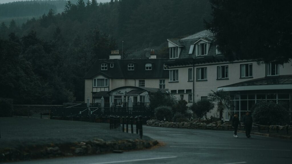 Secluded hotel in forested area during overcast day.