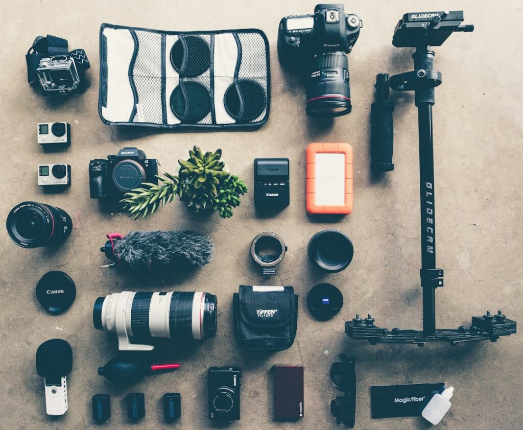 Assorted professional photography equipment laid out on floor.