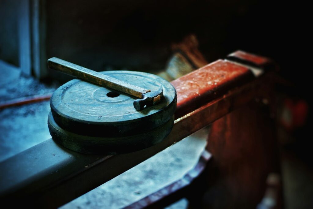 Old gym equipment, weightlifting plate, and bar.