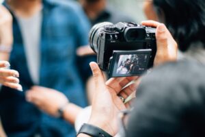 Person taking photo with digital camera.