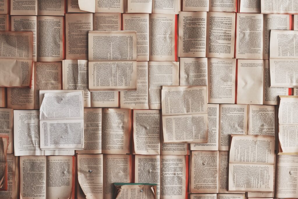 Wall covered in open vintage books.