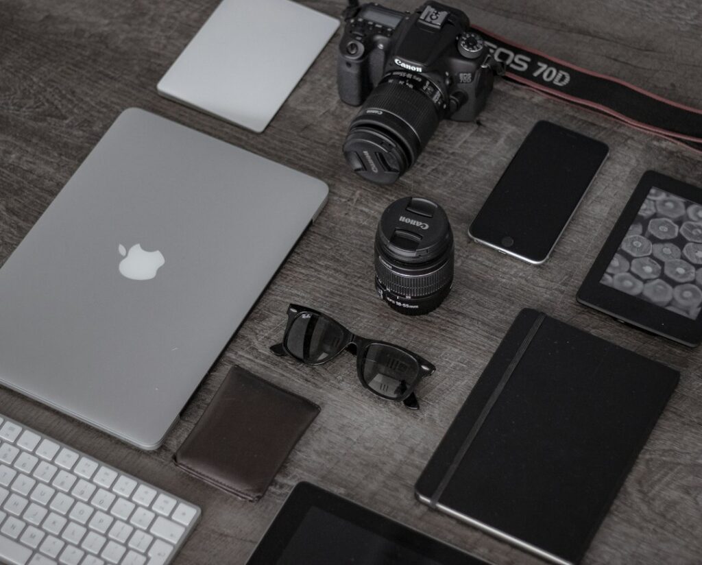 Modern tech gadgets and photography equipment on desk.