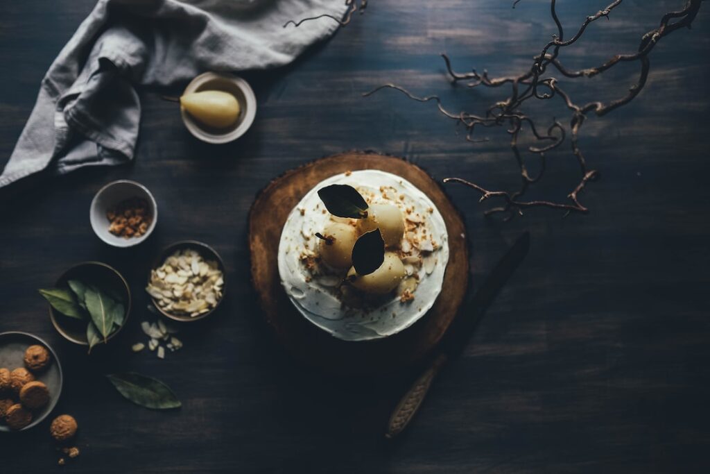 Gourmet cake with pears on rustic wooden table.