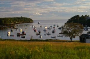 Harbor with boats, sunset, coastal town, serene sea